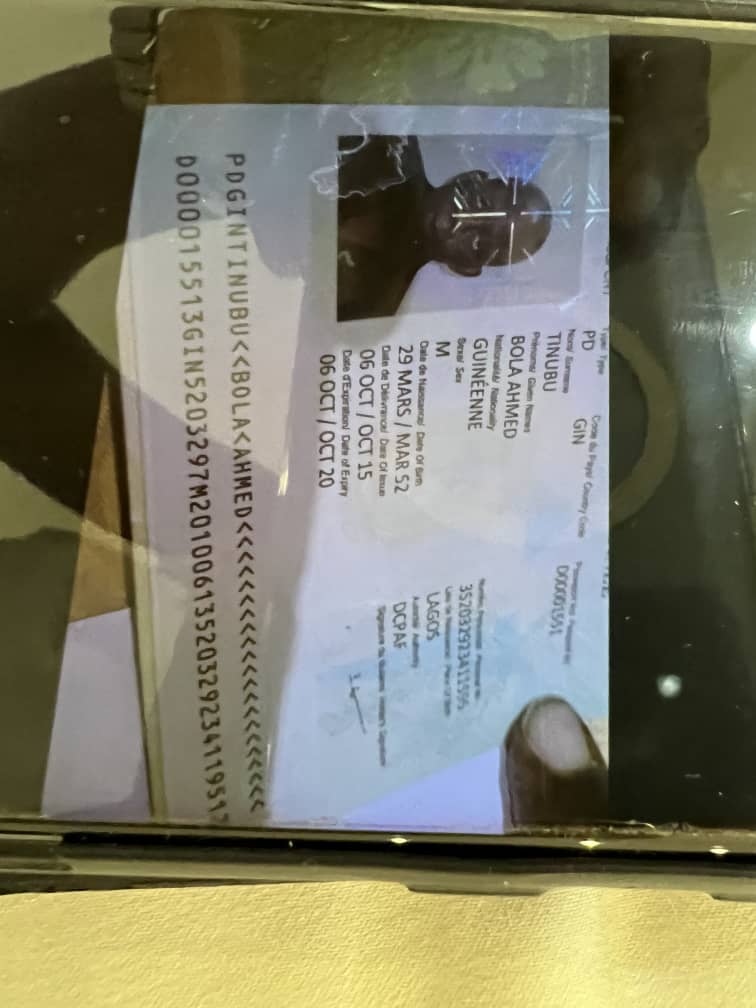 Trouble In APC Camp As Trending Photos Show Guinea-Conakry Passport of Bola Tinubu