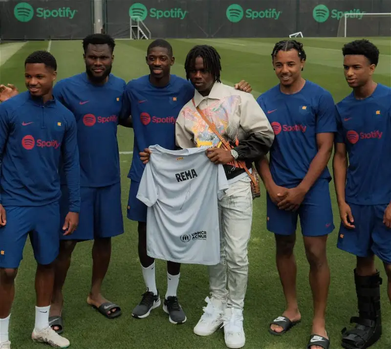 Rema Visits Barcelona Players During Training, Gets Customised Jersey