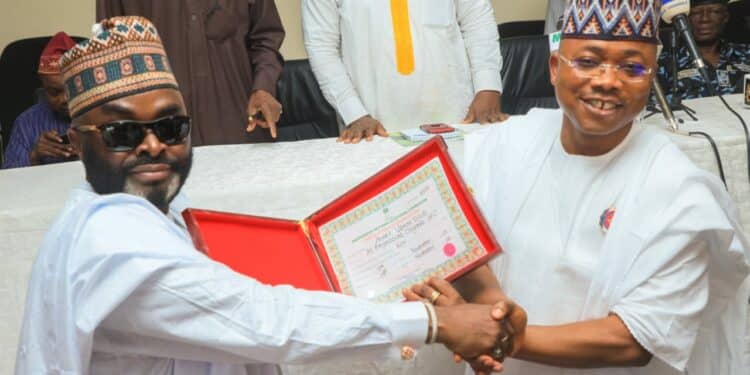 Reactions As Ododo Kneels To Present Certificate Of Return To Yahaya Bello