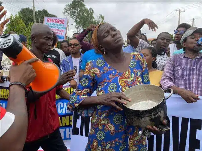 Hunger Protest: Woman With ‘Empty Pot’ Joins Lagos Protest [Video]