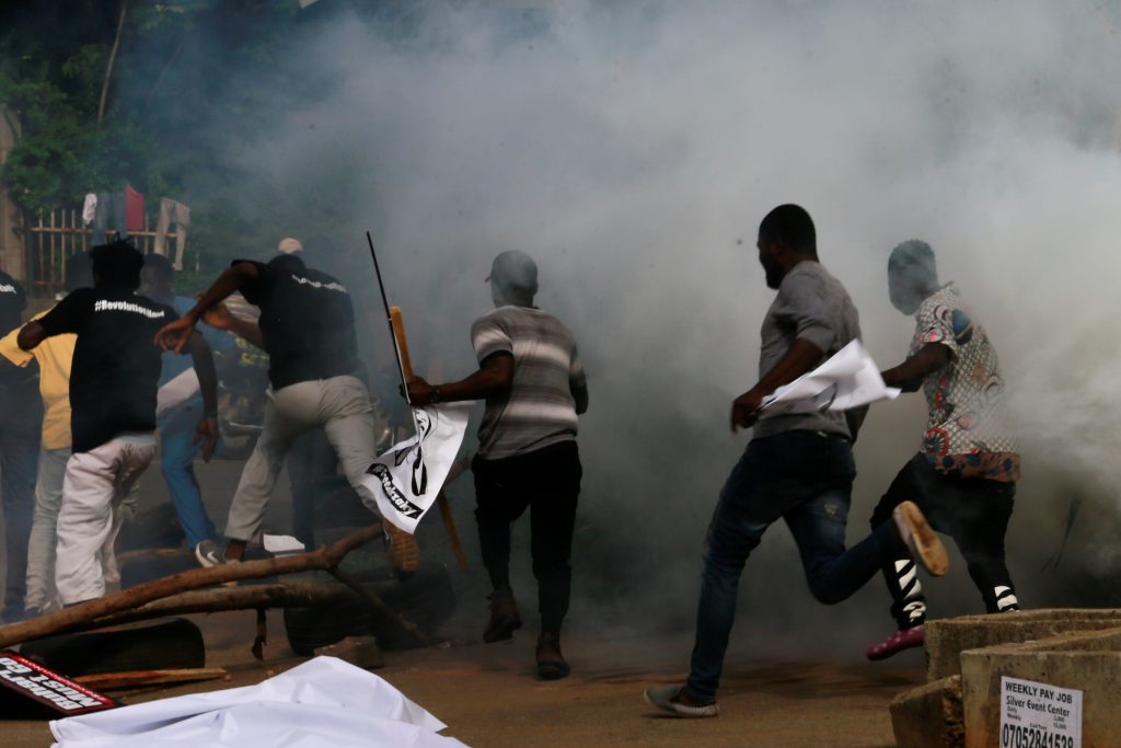 Moment Nigerian Immigration Officer 'Accidentally Shoots Self Three Times' While Barricading Protesters In Maiduguri